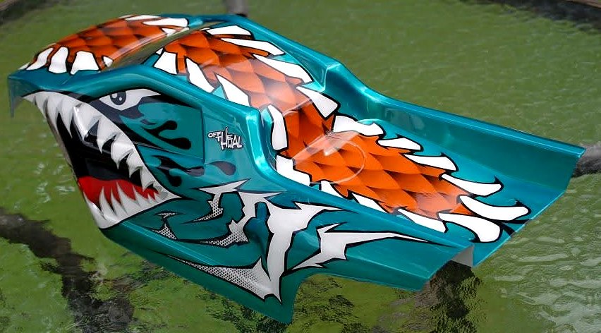 Pearl teal RC body painted as a shark with an open toothy mouth and orange scales